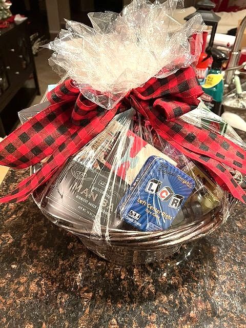 Gift basket wrapped in cellophane with a red-and-black buffalo plaid bow