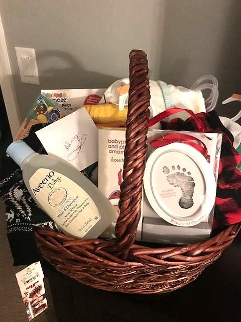 New baby basket with baby wash, a footprint keepsake frame and baby essentials
