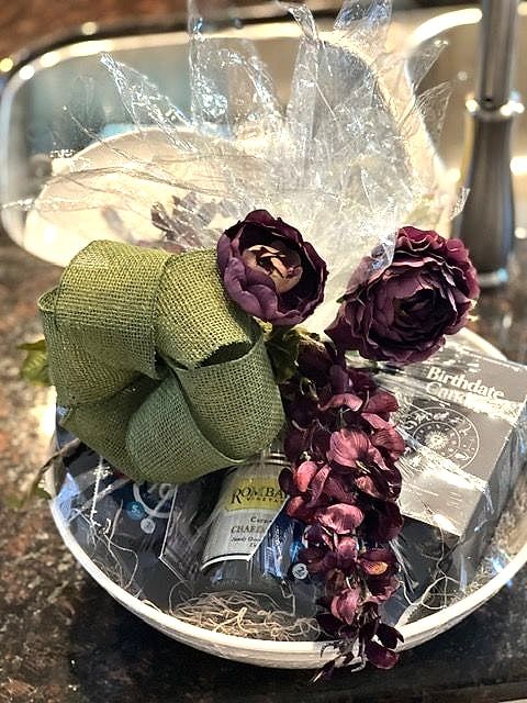 Birthday gift bowl with plum-colored flowers and a big green burlap bow