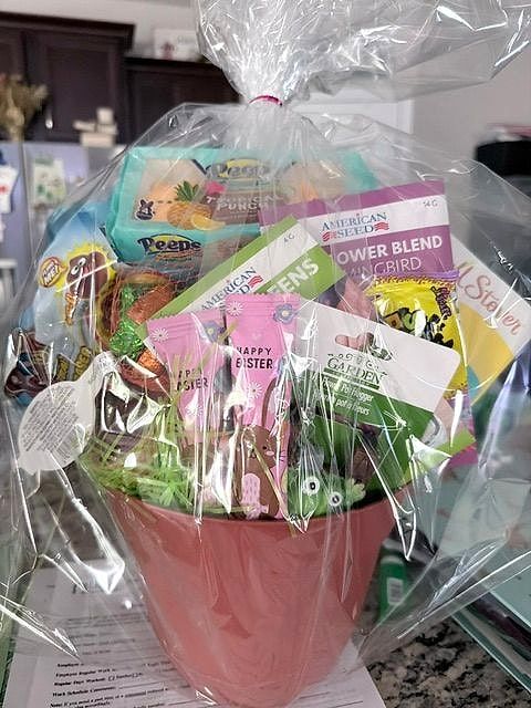 Pink flowerpot filled with spring and Easter goodies, wrapped in cellophane